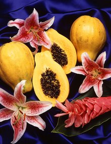 Arrangement of sliced and whole papayas